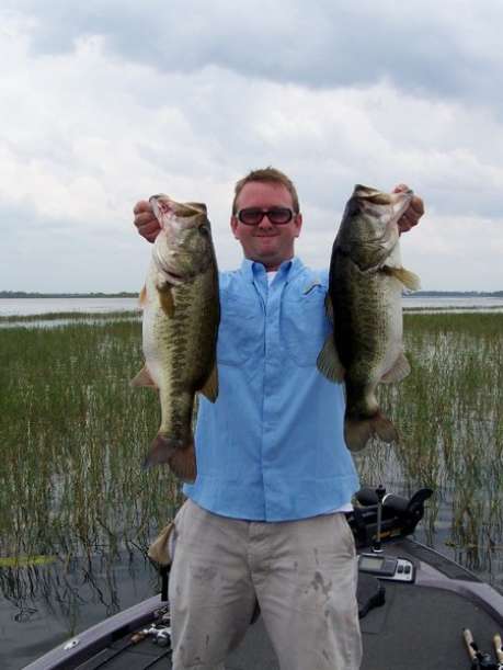 bass fisherman with two fish